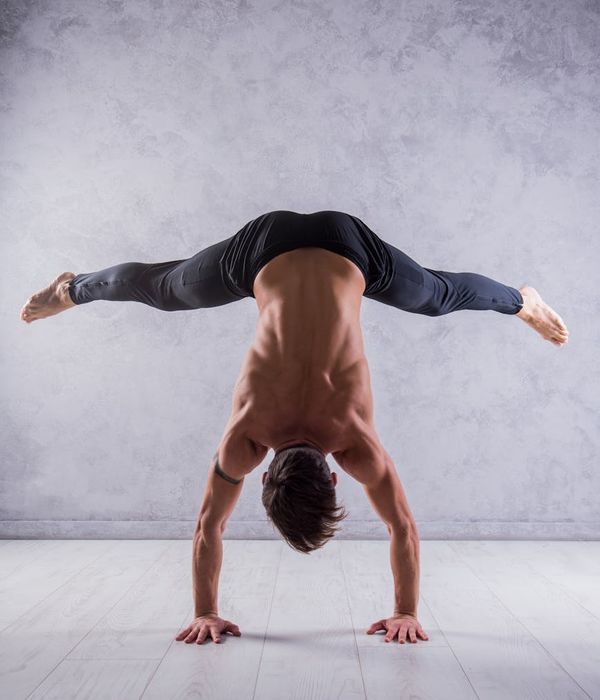 Man in a controlled strength pose, showing focus and stability.